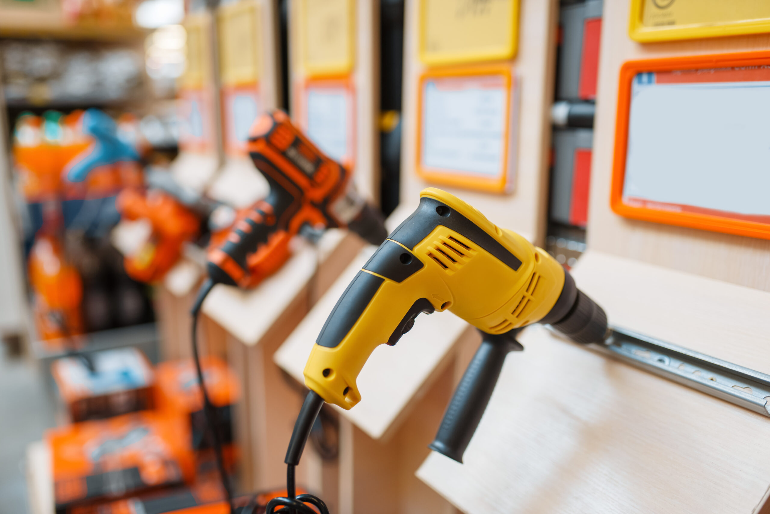 Hardware store assortment, shelf with electro drills, nobody. Power tools choice in diy shop, rows of products, electric instrument